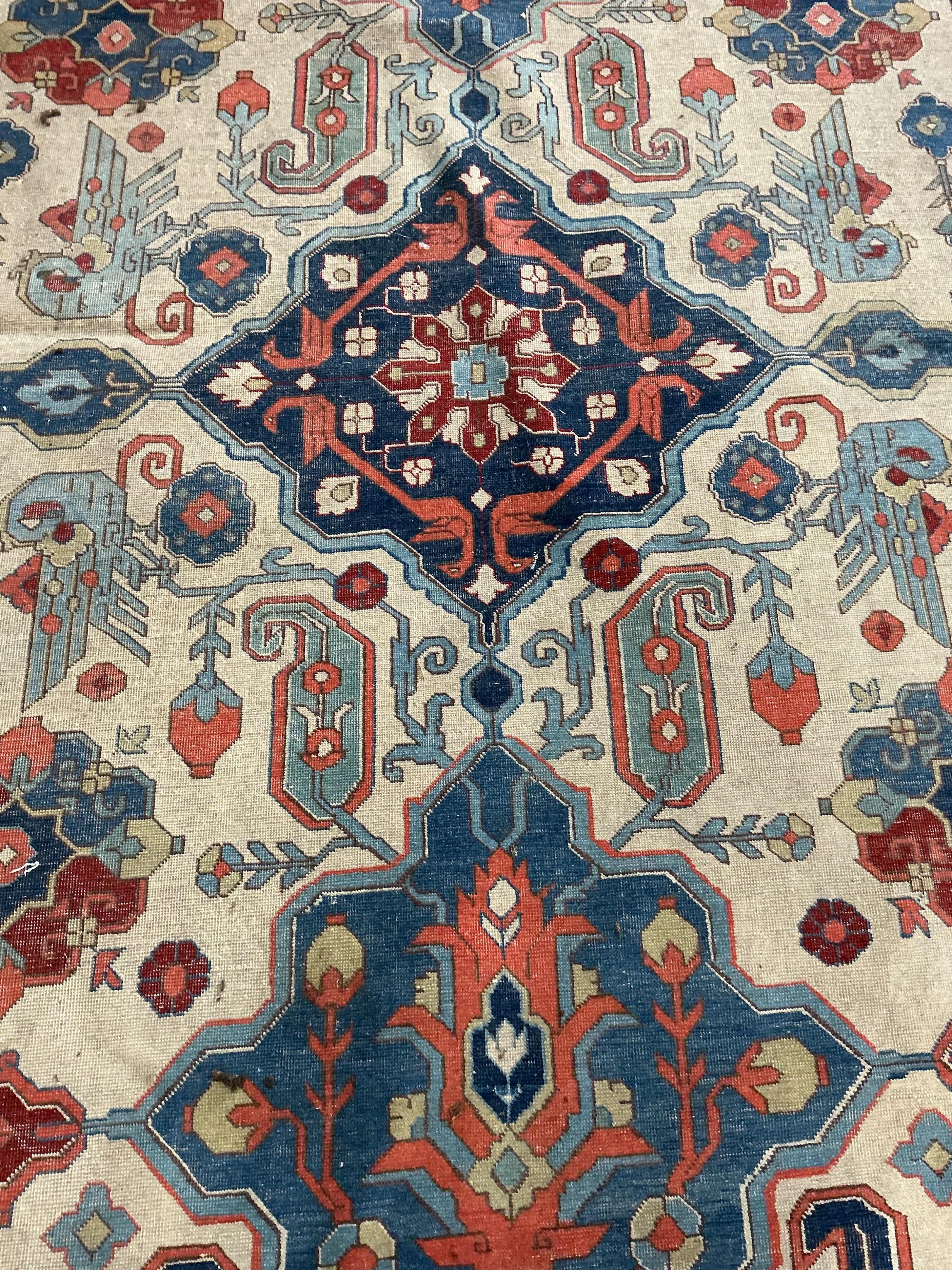 A Persian ivory ground Shirvan style carpet, approximately 300 x 198cm